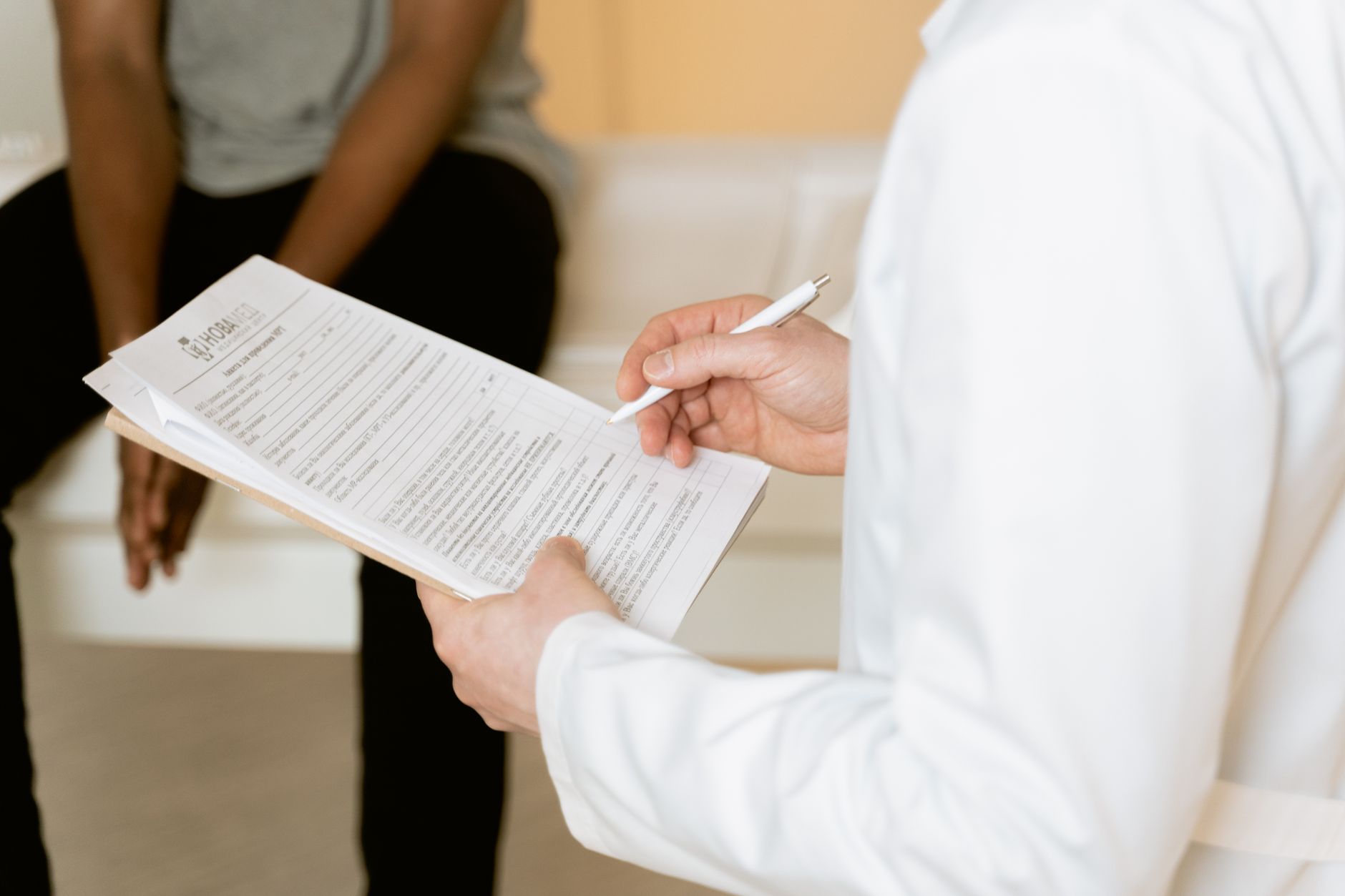 Profissional de saúde analisa um formulário durante consulta em uma clínica.